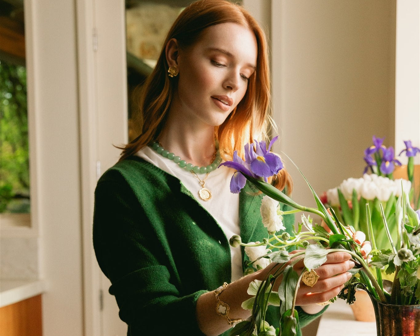 Woman arranging flowers in a home setting