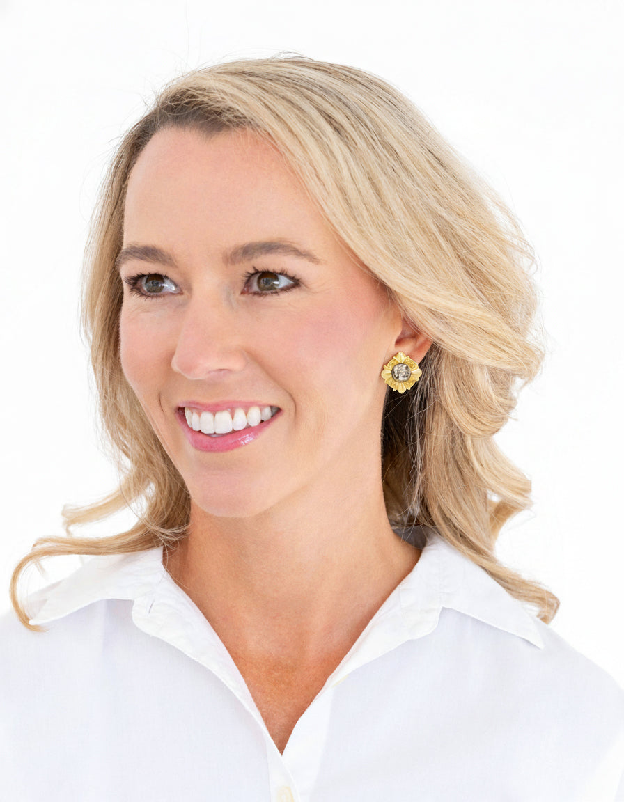 Pair of gold and silver earrings on a white background