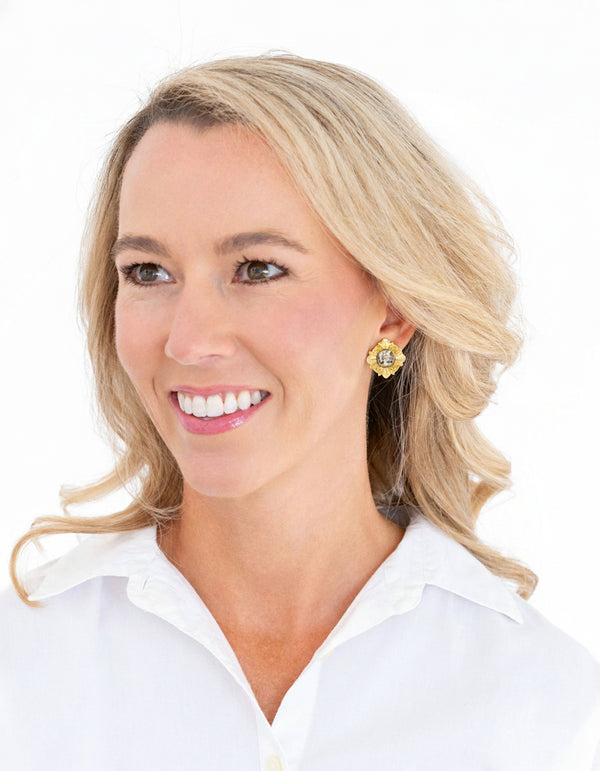 Pair of gold and silver earrings on a white background